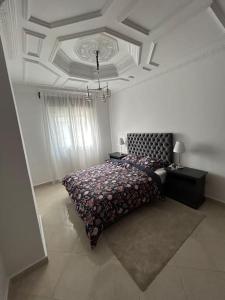a bedroom with a bed and a coffered ceiling at Tanger lovely apart only family in Tangier