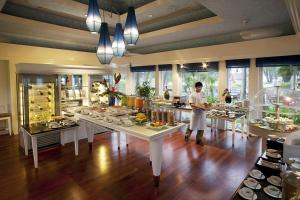 a man in a kitchen with a buffet of food at Dusit Thani Laguna Phuket in Bang Tao Beach