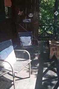 a chair and a chair on a patio at Loft Jardim Imbassai in Imbassai