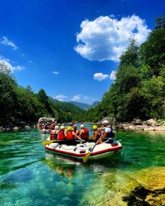 a group of people in a raft on a river at Rafting Camp Modra Rijeka in Šćepan-Polje