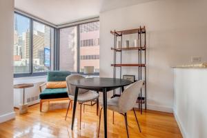 a dining room with a table and chairs at Midtown 1br w doorman gym nr Times Square NYC-1208 in New York