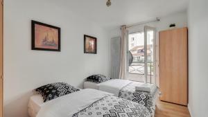 ein weißes Zimmer mit einem Bett und einem Fenster in der Unterkunft Chic apart with parking and balcony near Paris in Aubervilliers
