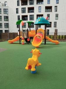 a playground with a toy pooh on a playground at Apartamenty Bokserska in Warsaw