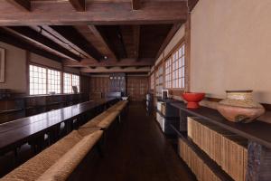 a row of benches in a large room with windows at 杜人舎 Morito-Sha in Nanto