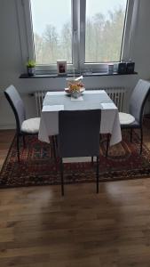 a dining room table with two chairs and a bowl of fruit on it at Appartment B 40 in Pirmasens