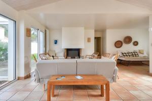 a living room with a couch and a table at Maison pour 14 - 150 m de la plage de la Clère in Noirmoutier-en-l'lle