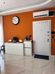 a room with a white door and a clock on the wall at Cozy 2-Bedroom Apartment, Cleopatra Beach, Alanya in Alanya