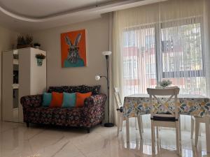 a living room with a couch and a table at Cozy 2-Bedroom Apartment, Cleopatra Beach, Alanya in Alanya