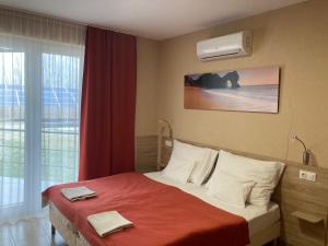 a bedroom with a bed with two towels on it at Nautilus Étterem és Panzió in Dabas