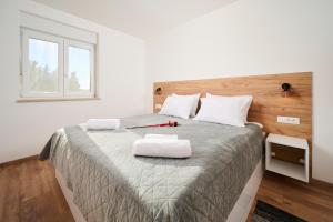 A bed or beds in a room at Apartma Morje