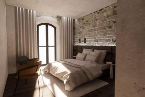 a bedroom with a bed and a brick wall at La Ferme des Vignes by ExplorHome in Labatie-dʼAndaure