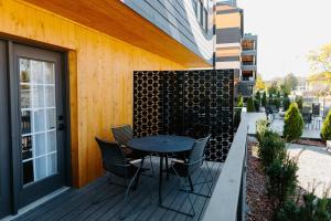 a patio with a table and chairs next to a building at The Vinyl at Music Row - Garden Suite in Nashville