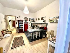 a living room with a table and a couch at La Siciliana-di fronte la Cattedrale in Palermo