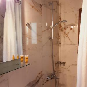 a bathroom with a shower with a shower curtain at Parselia in Therma