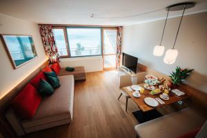 a living room with a couch and a table at Apartments am See in Egg am Faaker See