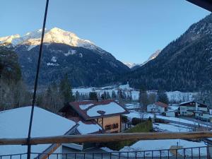 a view of a snow covered mountain from a house at Haus Gratz in Bach