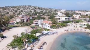 an aerial view of a beach with chairs and condos at Marathi Apartments in Marathi