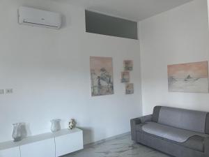 a living room with a couch and pictures on the wall at B&B mare mio in Pescara +35 photos