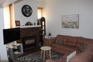 a living room with a couch and a fireplace at The Cosy House - Central Albury in Albury