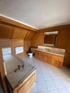 a large kitchen with a sink and a counter at Maison pour 15 personnes - Piscine - 50 min /Paris in Poigny-la-Forêt
