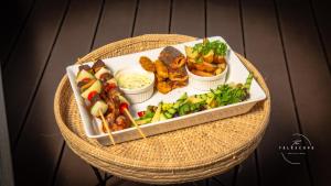 a tray of food with different types of food on a table at The Telescope Boutique Lodge in Victoria Falls