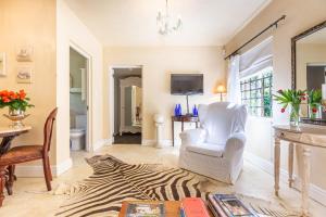 a living room with a zebra rug and a chair at Devon Castle Orchard Cottage in Stellenbosch