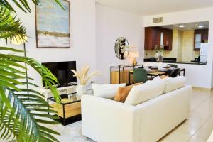 a living room with a white couch and a table at Vacation Home In Best Part of Dubai in Dubai