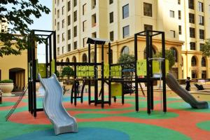 a playground with a slide in a park at Vacation Home In Best Part of Dubai in Dubai