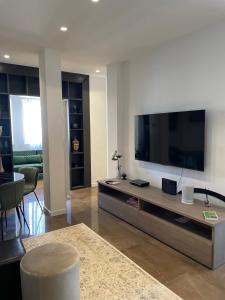 ein Wohnzimmer mit einem großen Flachbild-TV in der Unterkunft EUR suite BEETHOVEN in Rom