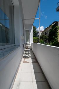 two chairs sitting on a balcony next to a window at Fully Equipped & Modern Designed Spectacular 3BR in Istanbul