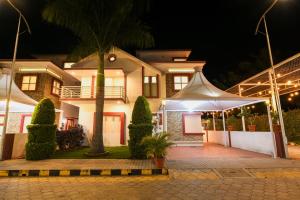 a house with a tent in front of it at night at Yuvraj Heritage Shelter Resort in Hosa Kannambādi