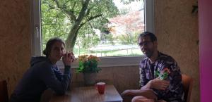 a man and a woman sitting at a table at Huisje de Bosrand in Bant
