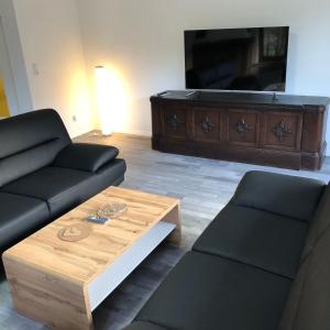 a living room with a couch and a coffee table at FeWo Wald Idyllika in Willingen