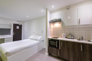 una pequeña cocina con cama y lavabo en University of Bath City Accommodation, en Bath