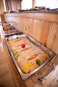 a buffet with a large casserole dish with ingrediants at Dahabiya Akhnaton Every Monday from Esna to Aswan for 4 Nights in Luxor