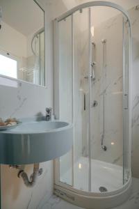 a bathroom with a sink and a shower at Hotel Faber in Rimini