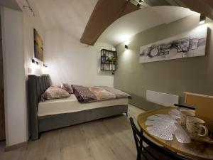 a small bedroom with a bed and a table at Adamas in Celje