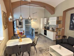 a living room and kitchen with a table and chairs at Adamas in Celje