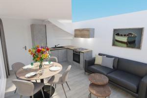 een woonkamer met een tafel en een bank bij 103D nieuwe vakantiewoning met sauna in Westkapelle