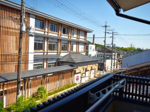 a view of a building from a balcony at Kyoto Tabisou Kasumi in Kyoto