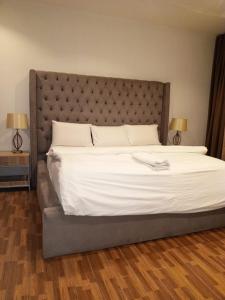 a large bed with a large headboard in a bedroom at Victoria Bay in Lagos