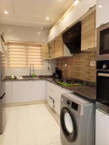 a kitchen with a washing machine in a kitchen at Victoria Bay in Lagos
