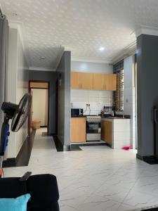 a large kitchen with a stove top oven at Precious Bahai nest 1BDR wifi Netflix in Kampala