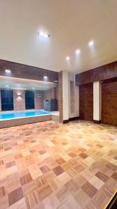 a large room with a wooden floor and a swimming pool at Family House in Cagayan de Oro City in Cagayan de Oro