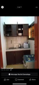 a kitchen with wooden cabinets and a stove at Sawadogo meublée in Ouagadougou