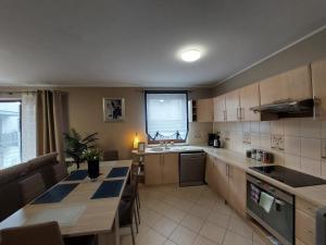 a kitchen with a table and a counter top at SAS Apartamenty Green Park in Szczecin