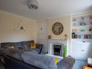 a living room with two couches and a fireplace at Bumble Cottage in Chipping Campden