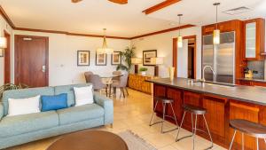 a living room with a couch and a kitchen at Ko Olina Beach Villas B403 in Kapolei
