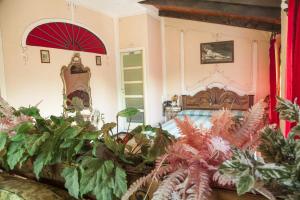 a bedroom with a bed with a red umbrella at Hotel Villino Della Flanella in Modena