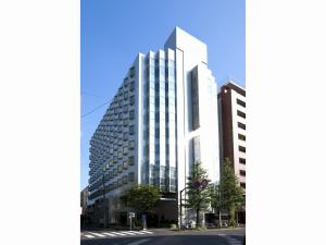 an architectural rendering of a tall building on a street at Hotel Sunlite Shinjuku in Tokyo